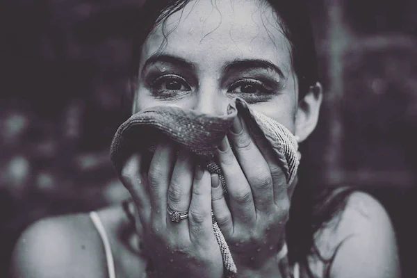 Close-up portrait of a woman in the rain.