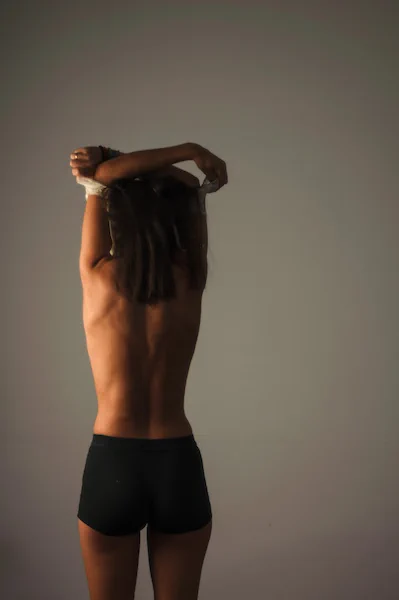 Naked woman photographed from the back.